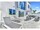 This home's backyard features a patio with dining and lounge furniture, and a sliding glass door entrance at 7770 Sandy Ridge Dr # 142, Kissimmee, FL 34747