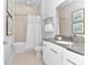 Modern bathroom with a shower-tub combination, neutral tile, and a white vanity with ample storage at 7770 Sandy Ridge Dr # 142, Kissimmee, FL 34747
