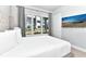 Well-lit bedroom featuring a large window, neutral wall color, and a wall-mounted television at 7770 Sandy Ridge Dr # 142, Kissimmee, FL 34747