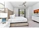 Well-lit bedroom with stylish decor, a tufted headboard, and a wall-mounted television at 7770 Sandy Ridge Dr # 142, Kissimmee, FL 34747