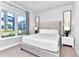 Serene bedroom features a tufted headboard, neutral colors, and natural light creating a relaxing atmosphere at 7770 Sandy Ridge Dr # 142, Kissimmee, FL 34747