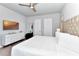 Cozy bedroom featuring a ceiling fan, wall-mounted television, and neutral decor at 7770 Sandy Ridge Dr # 142, Kissimmee, FL 34747