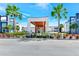 Inviting building facade with palm trees, well-kept landscaping, and a welcoming entrance, perfect for community residents at 7770 Sandy Ridge Dr # 142, Kissimmee, FL 34747