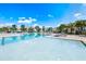 Brightly lit pool deck with plenty of room for relaxing in the sun, with comfortable lounge chairs, and shady umbrellas at 7770 Sandy Ridge Dr # 142, Kissimmee, FL 34747
