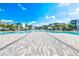 Spacious community pool area featuring lounge chairs, shade umbrellas and beautifully landscaped surroundings at 7770 Sandy Ridge Dr # 142, Kissimmee, FL 34747