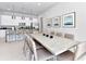 Bright dining area featuring a modern kitchen, bar seating, and a stylish, oversized dining table at 7770 Sandy Ridge Dr # 142, Kissimmee, FL 34747