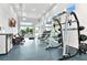 Bright gym area with gym equipment, weights, mirrors, and a wall mounted television at 7770 Sandy Ridge Dr # 142, Kissimmee, FL 34747