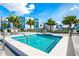 Inviting community hot tub for relaxing and unwinding in the sunshine, surrounded by modern lounge chairs at 7770 Sandy Ridge Dr # 142, Kissimmee, FL 34747