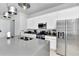 Modern kitchen with stainless steel appliances, island seating, and gray countertops provides a functional and sleek space at 7770 Sandy Ridge Dr # 142, Kissimmee, FL 34747