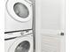 Convenient laundry room features a stacked washer and dryer, maximizing space in a clean, modern setting at 7770 Sandy Ridge Dr # 142, Kissimmee, FL 34747
