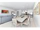 Open-concept living room with dining area and modern kitchen featuring stainless steel appliances and neutral tones at 7770 Sandy Ridge Dr # 142, Kissimmee, FL 34747