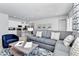 Open-concept living area featuring a modern kitchen, comfortable seating, and stylish decor at 7770 Sandy Ridge Dr # 142, Kissimmee, FL 34747