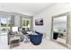 Comfortable living area with modern decor, a large mirror, and patio access for relaxed living at 7770 Sandy Ridge Dr # 142, Kissimmee, FL 34747