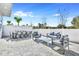 This spacious outdoor patio features stylish furniture, including a dining set and seating, enclosed by a white fence at 7770 Sandy Ridge Dr # 142, Kissimmee, FL 34747