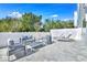 Outdoor patio features stylish furniture, including lounge chairs, a sofa, and armchairs, surrounded by a white fence at 7770 Sandy Ridge Dr # 142, Kissimmee, FL 34747