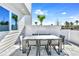 This spacious outdoor patio features a white dining table and seating area, enclosed by a pristine white fence at 7770 Sandy Ridge Dr # 142, Kissimmee, FL 34747