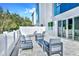 Outdoor patio features stylish furniture, including lounge chairs, a sofa, and armchairs, surrounded by a white fence at 7770 Sandy Ridge Dr # 142, Kissimmee, FL 34747
