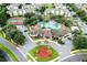 Aerial view of the community clubhouse, pool, and surrounding residences at 8121 Fan Palm Way, Kissimmee, FL 34747