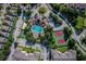 Aerial view of community amenities, including a pool, clubhouse, tennis courts, and lush landscaping at 8121 Fan Palm Way, Kissimmee, FL 34747