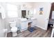 Bathroom offers double sink vanity, grey wood-look floors, and lots of storage at 8121 Fan Palm Way, Kissimmee, FL 34747