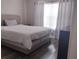 Comfortable bedroom features a large bed and window with natural light at 8121 Fan Palm Way, Kissimmee, FL 34747