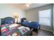 Guest bedroom with twin beds, baseball themed bedding, and natural light at 8121 Fan Palm Way, Kissimmee, FL 34747