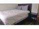 Well-appointed bedroom with sleek furniture, soft light and wood-look floors at 8121 Fan Palm Way, Kissimmee, FL 34747