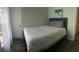 Cozy bedroom with a full bed, soft blue-grey walls, and natural light at 8121 Fan Palm Way, Kissimmee, FL 34747