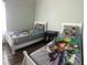 bedroom features two twin beds with whimsical bedding and lots of light at 8121 Fan Palm Way, Kissimmee, FL 34747