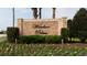 Elegant Windsor Palms community sign amidst colorful flowers and greenery, welcoming residents at 8121 Fan Palm Way, Kissimmee, FL 34747