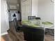 Bright dining area with a glass table and a view of the kitchen at 8121 Fan Palm Way, Kissimmee, FL 34747