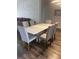Modern dining room features a sleek white table and six upholstered chairs at 8121 Fan Palm Way, Kissimmee, FL 34747