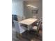 Elegant dining room with a glossy table, upholstered chairs, and accent wall at 8121 Fan Palm Way, Kissimmee, FL 34747