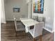 Stylish dining room with a modern table set and attractive artwork on the walls at 8121 Fan Palm Way, Kissimmee, FL 34747
