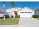 Well-maintained single-Gathering home with a two-car garage and manicured lawn at 8121 Fan Palm Way, Kissimmee, FL 34747