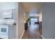 Bright hallway leading to an open kitchen and dining area with tile floors at 8121 Fan Palm Way, Kissimmee, FL 34747