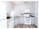 Modern kitchen with white appliances and gray countertops at 8121 Fan Palm Way, Kissimmee, FL 34747