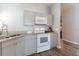 Well-lit kitchen with gray cabinets and granite countertops at 8121 Fan Palm Way, Kissimmee, FL 34747