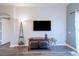 Cozy living room with a mounted TV, modern lamp, and neutral wall color at 8121 Fan Palm Way, Kissimmee, FL 34747