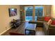 Comfortable living room featuring a sectional sofa and a view of the pool at 8121 Fan Palm Way, Kissimmee, FL 34747
