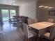 Spacious living area with view to the pool from the window and modern dining set at 8121 Fan Palm Way, Kissimmee, FL 34747