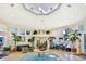 Well-decorated lobby with ample seating and elegant tropical plants at 8121 Fan Palm Way, Kissimmee, FL 34747