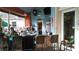 Outdoor bar with wicker stools, overhead fans, and mounted television for casual enjoyment at 8121 Fan Palm Way, Kissimmee, FL 34747