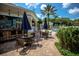 Relaxing outdoor patio with seating and tables, featuring a poolside bar area for residents and guests at 8121 Fan Palm Way, Kissimmee, FL 34747