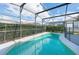 Inviting enclosed pool with turquoise water and privacy hedges at 8121 Fan Palm Way, Kissimmee, FL 34747