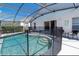 Enclosed swimming pool with sunny outdoor patio area and mature landscaping at 8121 Fan Palm Way, Kissimmee, FL 34747