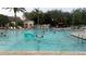 Community pool featuring a large swimming area and plenty of lounge seating for residents at 8121 Fan Palm Way, Kissimmee, FL 34747