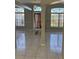 Bright and open empty room featuring tile flooring, neutral walls, and large windows with views at 852 Adour Dr, Kissimmee, FL 34759