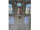 Bright foyer features tile flooring, large windows, and a decorative front door at 852 Adour Dr, Kissimmee, FL 34759