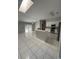 Open floor plan featuring a kitchen with stainless steel appliances and a breakfast bar at 852 Adour Dr, Kissimmee, FL 34759
